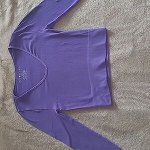 A purple eye candy crop top with Long sleves